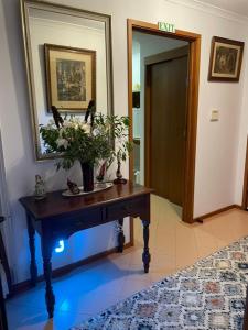 a hallway with a table with a plant on it at Bluff House in Saint Leonards