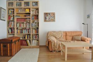 a living room with a couch and book shelves at Aiguaneu Sa Marina in Blanes