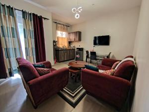 a living room with two couches and a table at Vine Suites Mbarara Fully Furnished 1BR - Ideal for Short & Long Stays in Mbarara