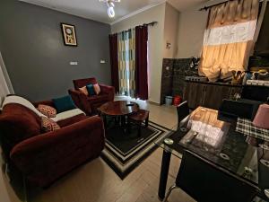 a living room with a couch and a table at Vine Suites Mbarara Fully Furnished 1BR - Ideal for Short & Long Stays in Mbarara