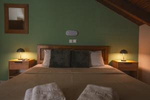 a bedroom with a large bed with two nightstandiatesiatesiatesiatesiatesiates at Thermora Hotel in Orma +10 photos