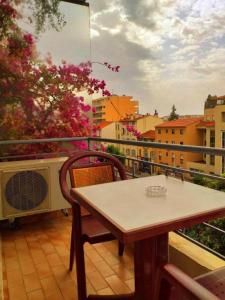 a table and chair on a balcony with a view of a city at Le Petit Château - Cannes in Cannes +32 photos