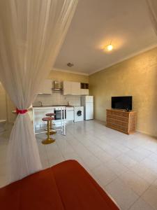 a living room with a kitchen with a table and a couch at Residenza Anagnina in Rome