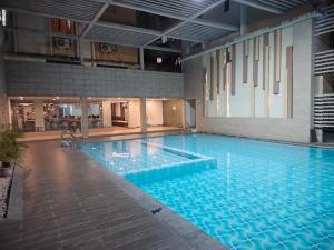 a large blue swimming pool in a building at Starlight Guest House in kolkata
