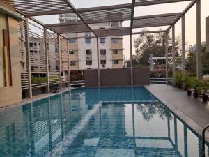 a swimming pool in a building with a building at Starlight Guest House in kolkata