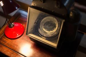 una macchina fotografica seduta su un tavolo accanto a una candela rossa di Fujiya a Minamioguni