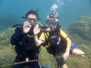 two people in scuba gear in the water at Nouvel Hotel in Saint-Raphaël