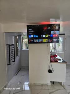 a kitchen with a tv on top of a wall at Emmanuel INN XI in Pierrefitte-sur-Seine