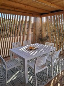 a white table and chairs on a patio at Panorama Mobilehome Vista Kornati with Pool in Drage +25 photos