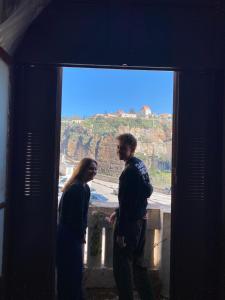 a man and a woman looking out of a window at Hostel le Rhumel in Constantine