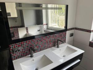 a bathroom with two sinks and a mirror at Adriatic View in Pješčana Uvala +23 photos