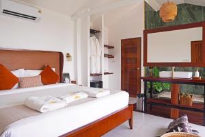 a bedroom with a large bed with a large screen at Secret Garden Eco Pool Villas in Ko Tao