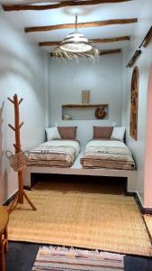 a room with two beds on the wall at Ryad Fnina in Tiznit