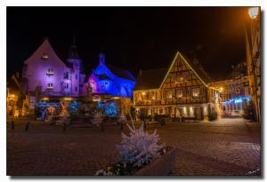 a lit up town at night with blue lights at Appartement à Mitzach in Mitzach +9 photos