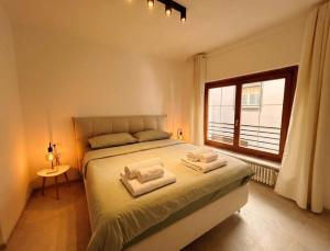 a bedroom with a bed with two towels on it at Centro Storico di Merano in Merano