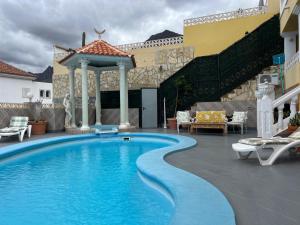 a swimming pool on a patio with a gazebo at Villa Tenerife Sur in Adeje