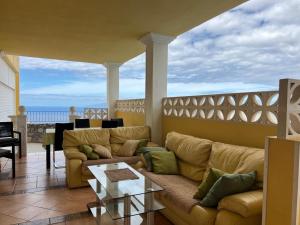 a living room with a couch and a table at Villa Tenerife Sur in Adeje