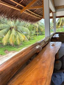 a wooden bench on the porch of a house at Onaza Homestay Bintang in Katiet