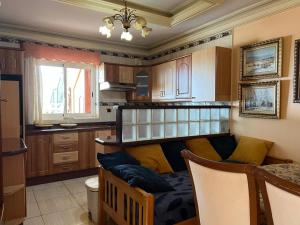 a living room with a couch in a kitchen at Villa Tenerife Sur in Adeje