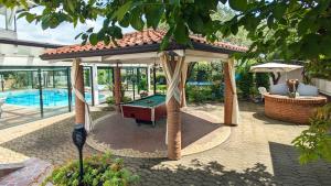 a gazebo with a pool table in a backyard at Fontana Wild West in Castelnuovo del Garda