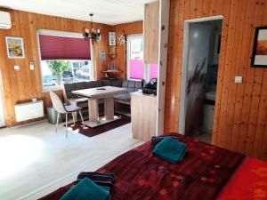 a living room with a table and a dining room at Bungalow Mika und Lizzy in Koserow