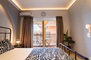 a bedroom with a bed and a balcony at Bella casa in Siolim +32 photos