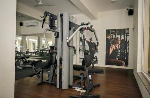 a gym with several tread machines in a room at Bella casa in Siolim
