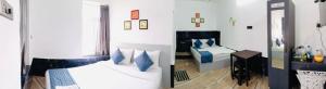 two pictures of a room with two beds at Hotel Bougainvillea in Cochin