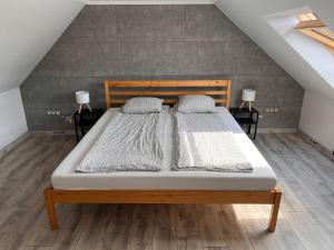 a bedroom with a bed with two pillows on it at Filkes Rezidence in Filkeháza