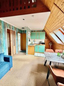a living room with a blue couch and a table at Ferienwohnung Sternenhimmel in Dranske