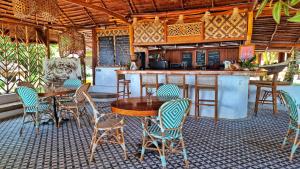 a patio with a table and chairs and a kitchen at Manoa Kei Boutique Villas in Letman