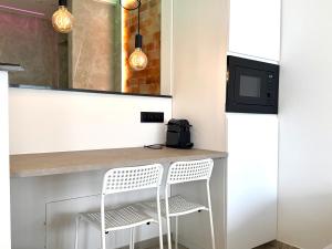 a kitchen with a counter with a stool and a microwave at Salt Spa de Panne center in De Panne