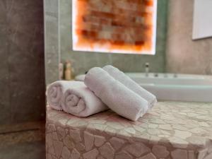 a pile of towels sitting on a counter in a bathroom at Salt Spa de Panne center in De Panne