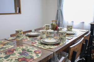 a table with plates and cups on top of it at Nagoya Kuwana Choco House in Yatomi 