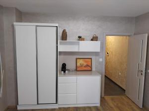a white book shelf in a room with a door at Apartment Moni 3 in Veliko Tŭrnovo