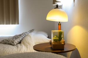 a lamp on a table next to a bed at Nagoya Kuwana Choco House in Yatomi  +51 photos