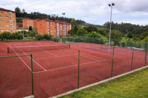 a tennis court with two tennis nets on it at Nova MSuites Xove in Lago