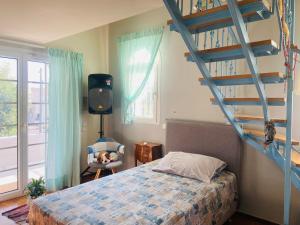a bedroom with a bed and a spiral staircase at Villa Eleni in Lagonissi +60 photos