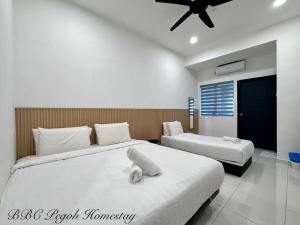 a bedroom with two beds and a ceiling fan at BBC Pegoh in Ipoh