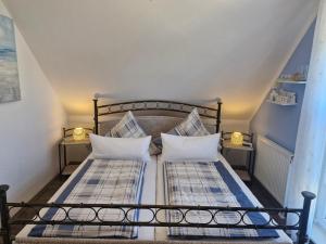 a bedroom with two beds with pillows on it at Lilly & Fine in Zingst