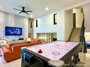 a living room with a large ping pong table at BBC Pegoh in Ipoh