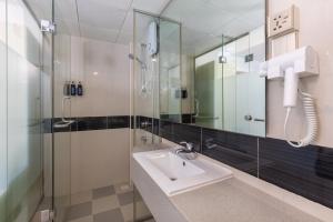 a bathroom with a sink and a shower at White Harp Beach in Hulhumale