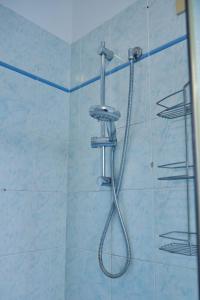 a shower with a shower head in a bathroom at Beach 300m Piazza Milano in Lido di Jesolo +12 photos