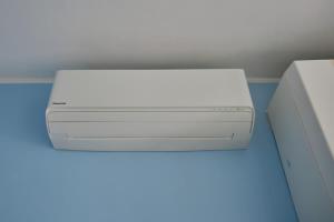 a white printer sitting on a shelf in a room at Beach 300m Piazza Milano in Lido di Jesolo