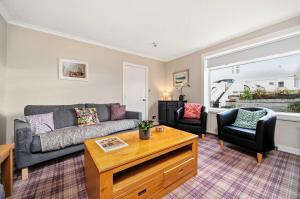 a living room with a couch and two chairs at 4-Bed Home Central Location & Garden in Oban