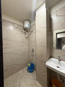 a bathroom with a sink and a shower at Hotel Jaya shree in Ujjain
