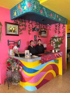 two people sitting at a colorful counter in a restaurant at Zolaria Hotel and Restaurant in Tagaytay