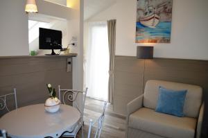 a living room with a table and a chair at Appartamenti Barzilai in Gabicce Mare