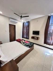 a bedroom with a large bed and a tv at Hotel Jaya shree in Ujjain +21 photos