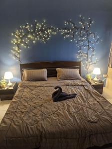 a black bird sitting on a bed in a bedroom at QG restaurant and guesthouse in Hua Hin
